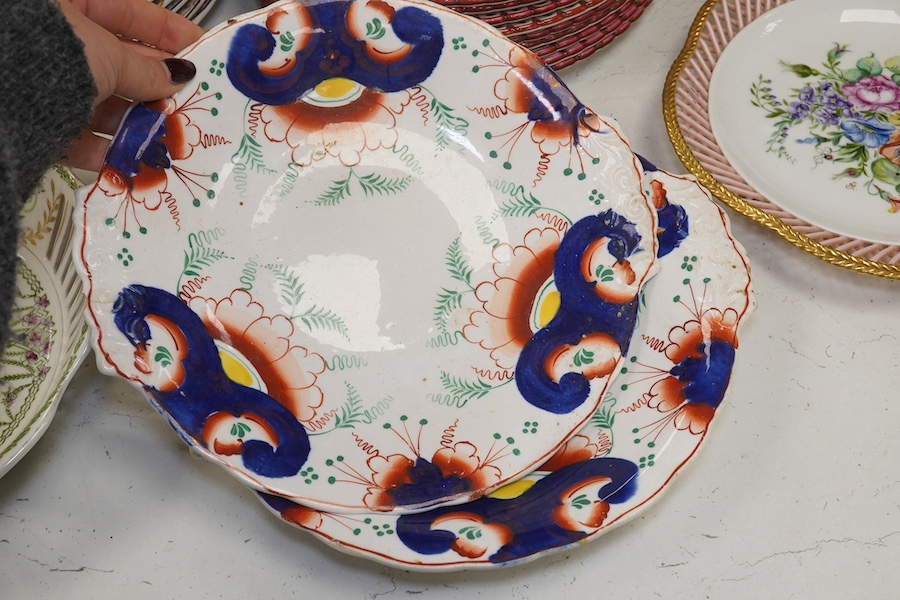 Ten French Luneville floral plates, a hand painted basket edged plate and various part dinner service plates, 24cm in diameter. Condition - mostly fair to good